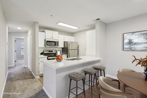 Cornelius apartment for rent - A kitchen with a white counter and bar stools.