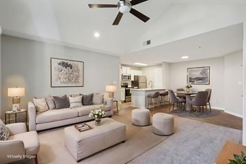 Cornelius apartment for rent - A living room with a white couch and a ceiling fan.