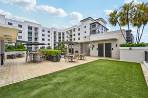 West Palm Beach apartment for rent - A large white building with a green lawn in front.