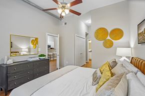 Atlanta apartment for rent - A bedroom with a white bed and a ceiling fan.