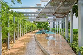 West Palm Beach apartment for rent - A walkway with a fountain in the middle of it.