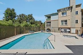 Walnut Creek apartment for rent - A swimming pool in front of a building with a fence around it.