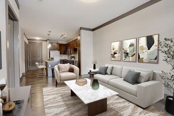 Nashville apartment for rent - A modern living room with a grey sofa, a coffee table, and a painting on the wall.