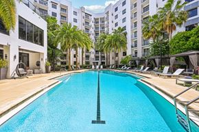 Eden Prairie apartment for rent - A large swimming pool in a residential area with palm trees.