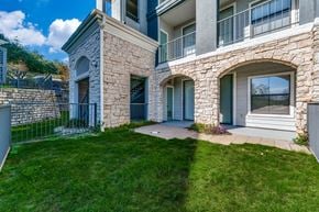 Austin apartment for rent - an exterior view of a house with a lawn and a walkway