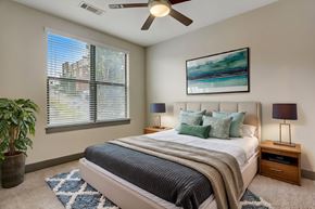 Nashville apartment for rent - Nashville Apartments - Octave Apartments - Bedroom with plush carpet, ceiling fan, and large windows with natural light