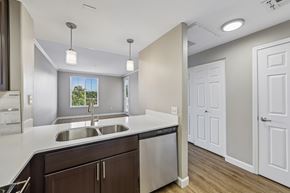 Walnut Creek apartment for rent - A modern kitchen with a stainless steel sink and brown cabinets.
