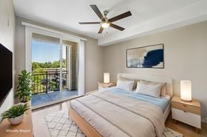Walnut Creek apartment for rent - A bedroom with a bed, a ceiling fan, and a painting on the wall.