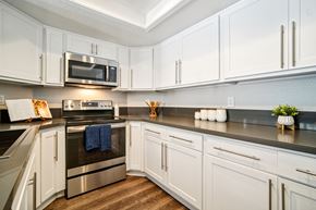 San Clemente apartment for rent - A kitchen with white cabinets and a stainless steel oven.