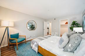 San Clemente apartment for rent - A bedroom with a bed, chair, and a mirror on the wall.