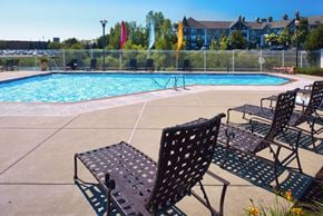 Woodbury apartment for rent - a swimming pool with patio furniture and chairs next to it