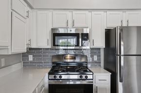 Austin apartment for rent - A modern kitchen with a stove and refrigerator.