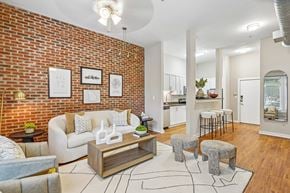 Atlanta apartment for rent - A living room with a white couch and a coffee table.