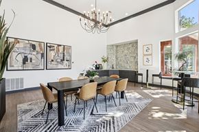 Plano apartment for rent - A dining room with a black table and chairs.