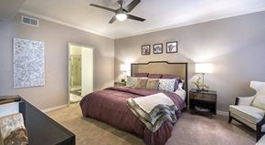 Mckinney apartment for rent - a bedroom with a bed and a ceiling fan