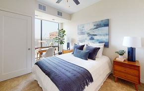 Minneapolis apartment for rent - a bedroom with a bed and a large window