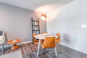 Seattle apartment for rent - Apartments for Rent Green Lake Seattle, WA - Circa Greenlake - Dining Area with Hardwood Floor, Round Table with Seating, and Standing Lamp.