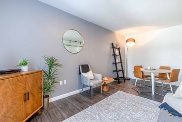 Seattle apartment for rent - a living room with a table and chairs and a mirror
