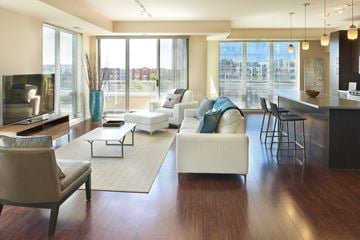 Minneapolis apartment for rent - a living room with couches and chairs and a kitchen with a large window