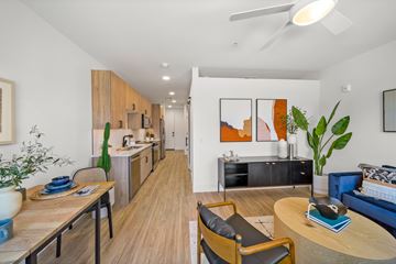 Phoenix apartment for rent - A modern living room with a dining table and chairs.