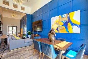 Phoenix apartment for rent - a living room with blue walls and a table with a statue