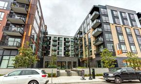 Minneapolis apartment for rent - A modern apartment complex with cars parked in front.