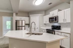 Woodstock apartment for rent - Pet-Friendly Apartments in Woodstock, GA – Lea Woodstock – luxury kitchen with stainless-steel appliances, white cabinets, and quartz countertops
