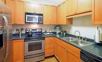 Maple cabinetry in kitchen with pantry