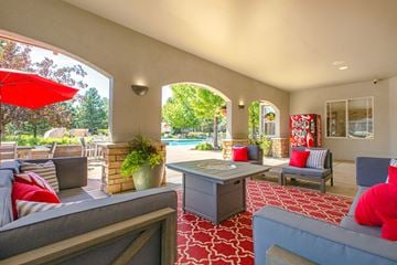 Highlands Ranch apartment for rent - A living room with a grey couch and red pillows.