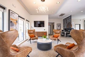 Scottsdale apartment for rent - a living room with chairs and a table and a television