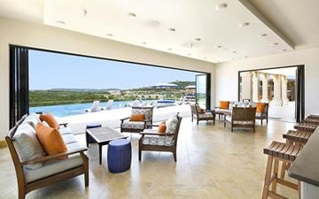 Austin apartment for rent - a living room with a view of the ocean and chairs and tables