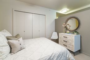 Seattle apartment for rent - a bedroom with a bed and a dresser with a mirror