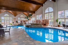 Omaha apartment for rent - a large swimming pool in a building with large windows