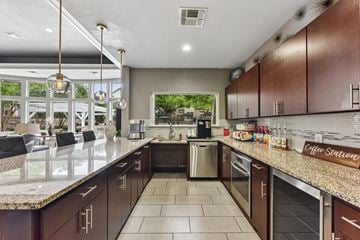 Round Rock apartment for rent - A kitchen with brown cabinets and a granite countertop.