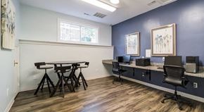 Cornelius apartment for rent - A business office with a table and chairs and two computers on a desk.
