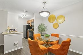 Marietta apartment for rent - A dining room with a glass table and orange chairs.