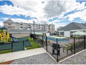 Littleton apartment for rent - a pool with a slide in front of a building