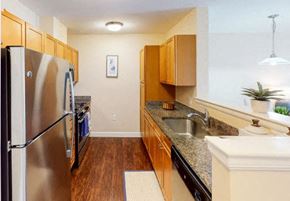 Littleton apartment for rent - a kitchen with a stainless steel refrigerator freezer and a stove top oven
