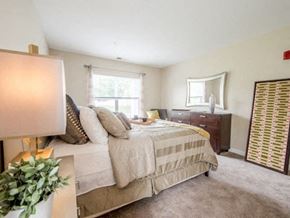 Littleton apartment for rent - a bedroom with a bed and dresser in it