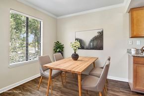 Walnut Creek apartment for rent - Walnut Creek, CA, Apartments for Rent - Park Lake at Walnut Creek - Dining Area With Wood Table, Upholstered Chairs, Wood-Style Flooring, and Large Window With Blinds.