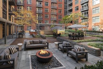 Two private courtyards with seating, outdoor grills, and fire pit
