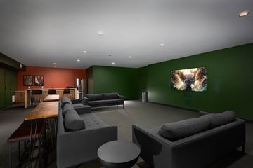 St. Louis apartment for rent - A modern living room with a grey couch and a wooden table.
