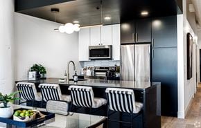 St. Louis apartment for rent - a black and white kitchen with a counter and chairs