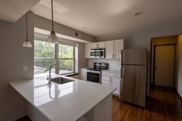 St. Louis apartment for rent - A kitchen with a white counter top and stainless steel appliances.