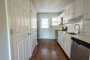 St. Louis apartment for rent - a kitchen with white cabinets and a stainless steel dishwasher