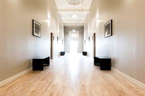St. Louis apartment for rent - A long hallway with wooden floors and white walls.