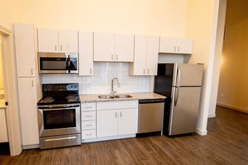 St. Louis apartment for rent - A kitchen with white cabinets and stainless steel appliances.