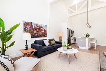 St. Louis apartment for rent - A living room with a blue couch and a painting on the wall.