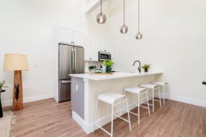 St. Louis apartment for rent - A kitchen with a white island and bar stools.