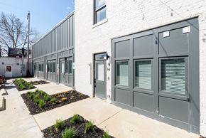 St. Louis apartment for rent - A white building with grey doors and windows.